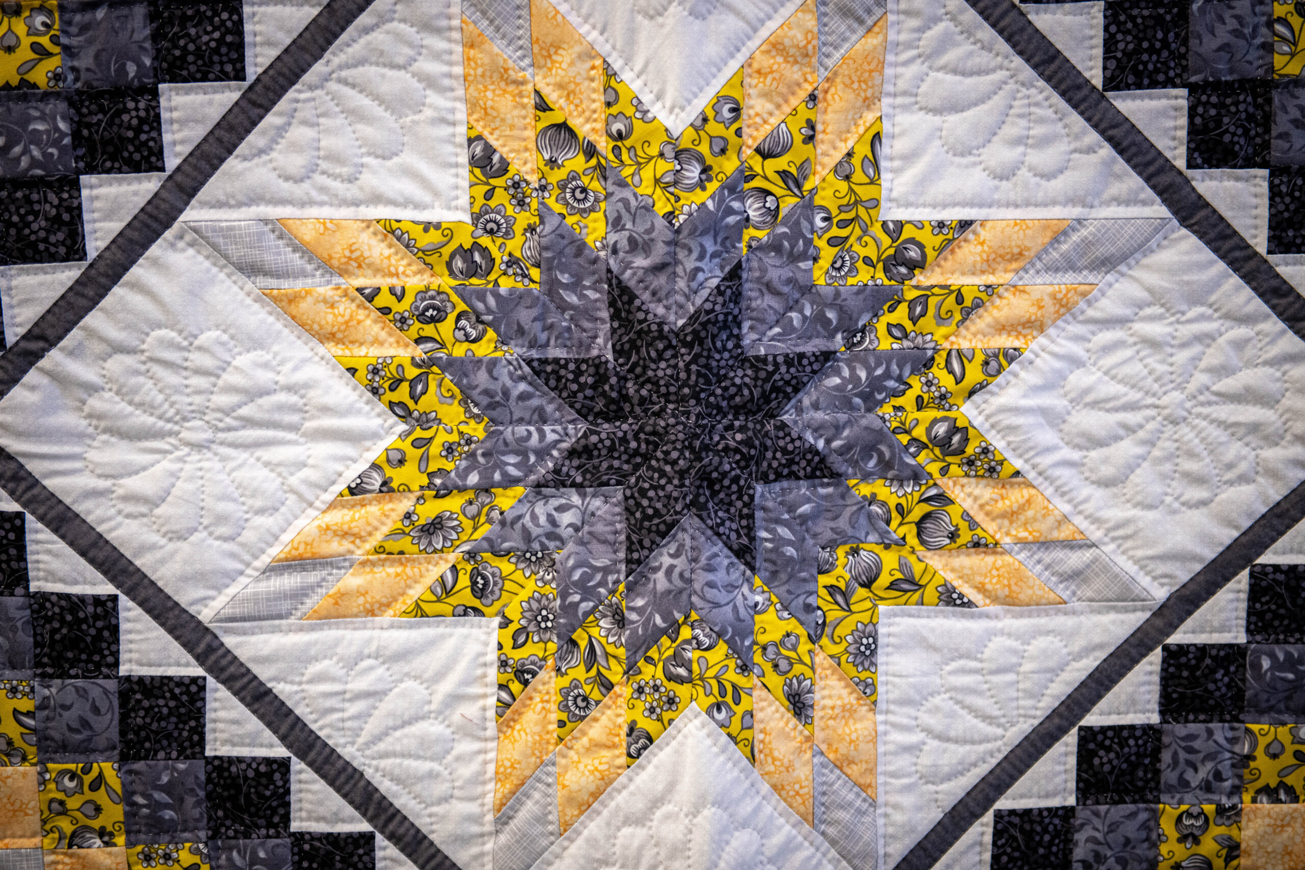 Beautiful yellow and purple hand stitched quilt by Lancaster County Amish.