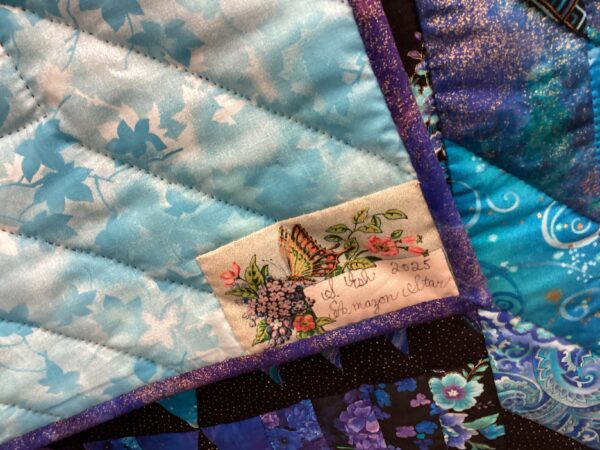 Amazon Star backing fabric and quilters signature.