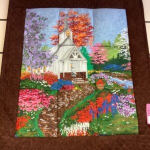 Springtime White Church wall hanging created by many colors of thread.