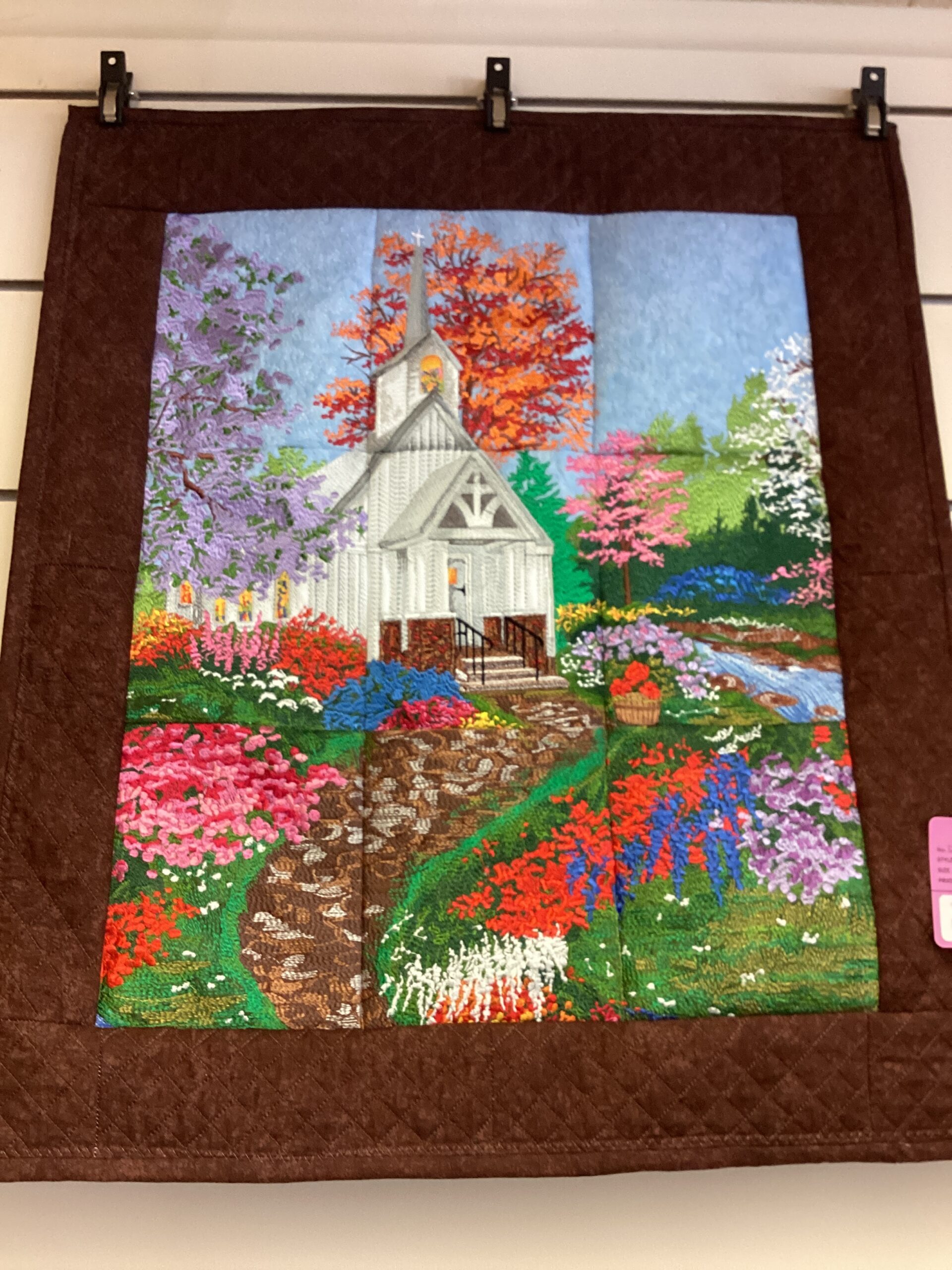 Springtime White Church wall hanging created by many colors of thread.