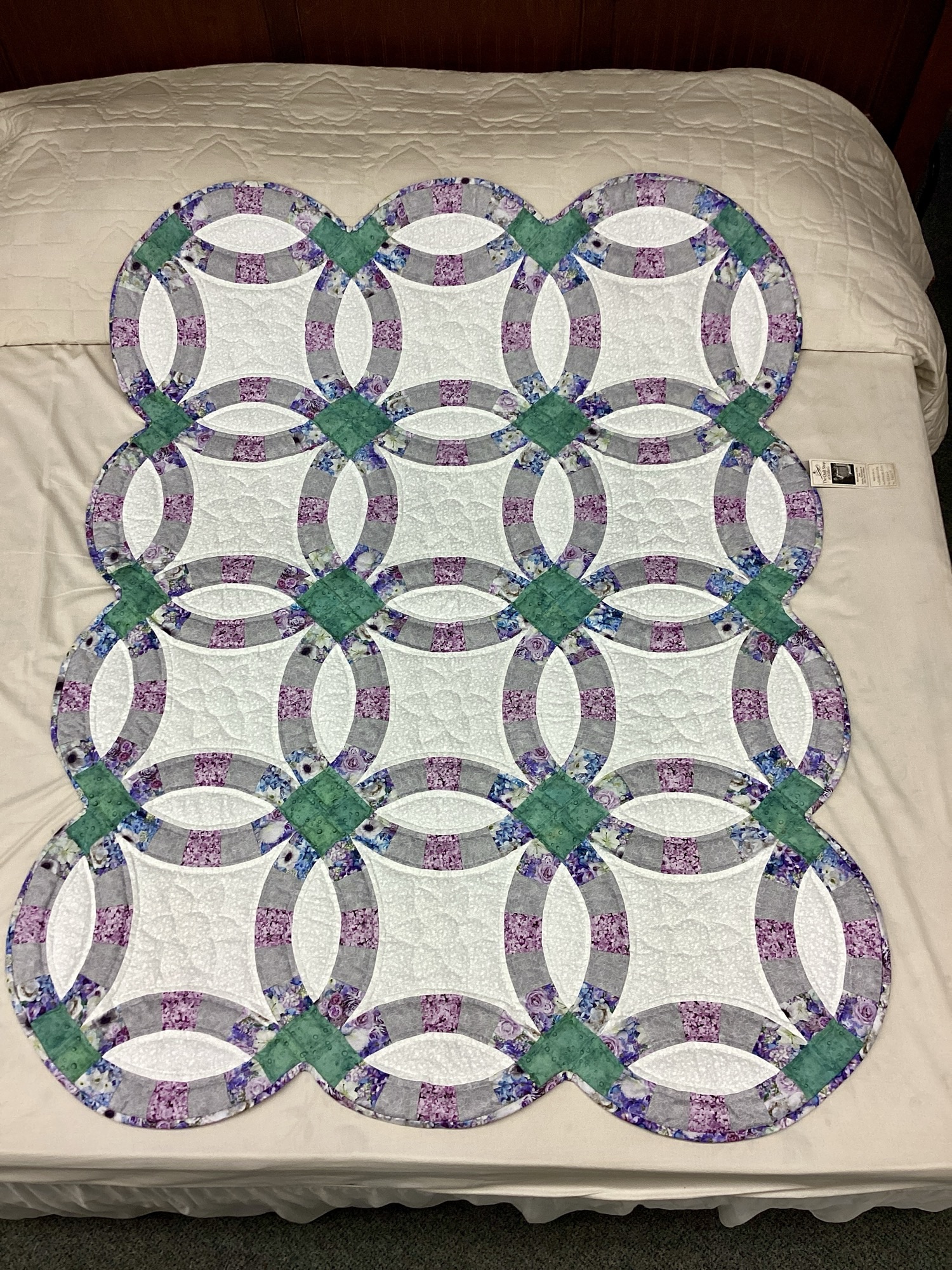 Handmade Amish Double Wedding Ring quilt throw in sage green and lavender floral fabric