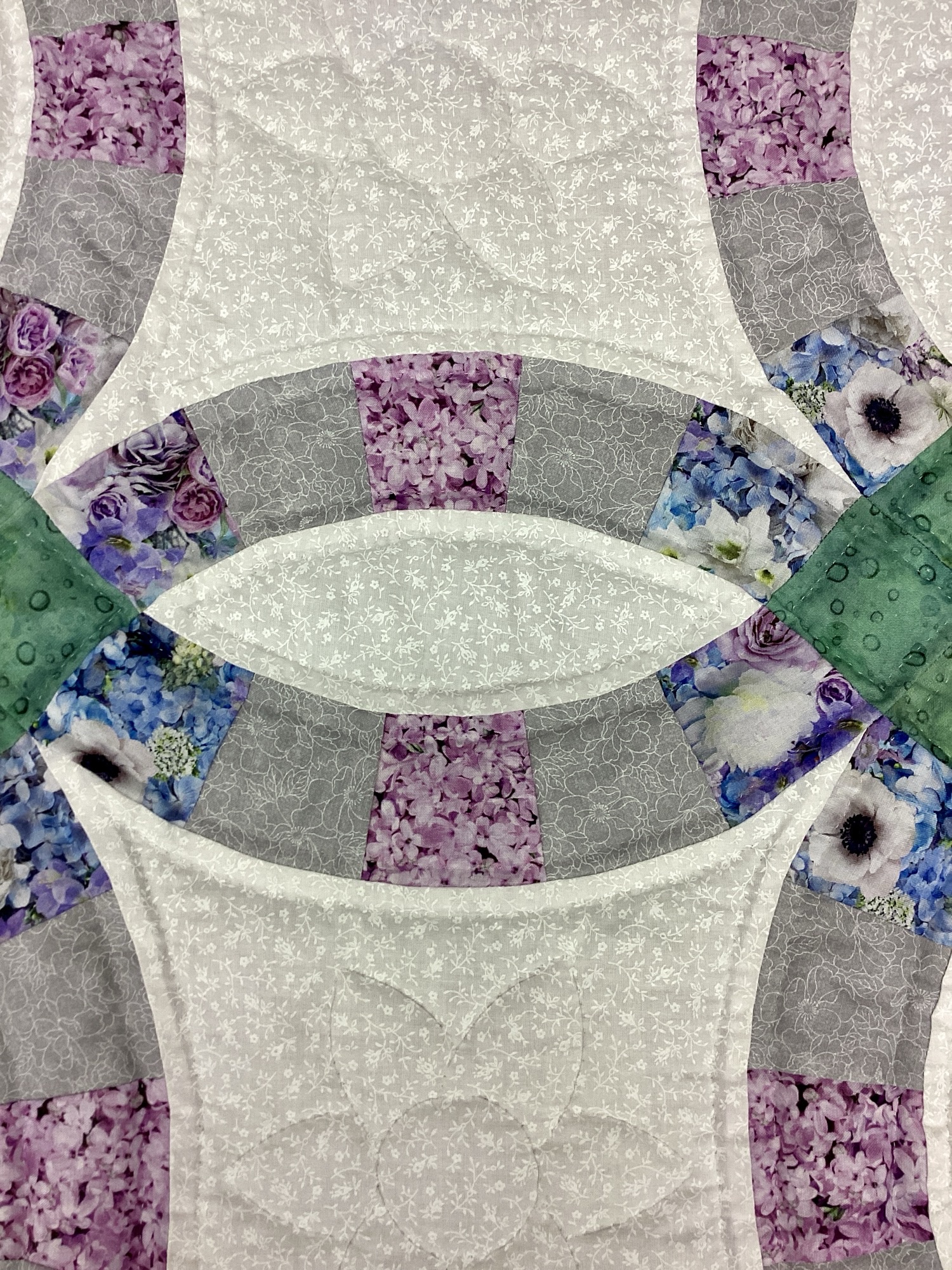 Hand-stitched Double Wedding Ring Amish quilt throw with floral calico fabrics