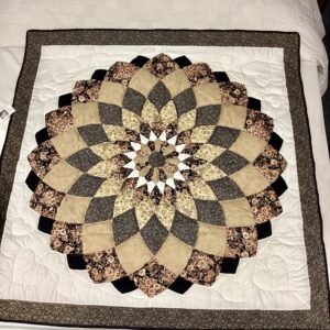Black and gold Giant Dahlia handmade Amish throw quilt with floral calico fabrics and hand-stitched quilting from Lancaster County