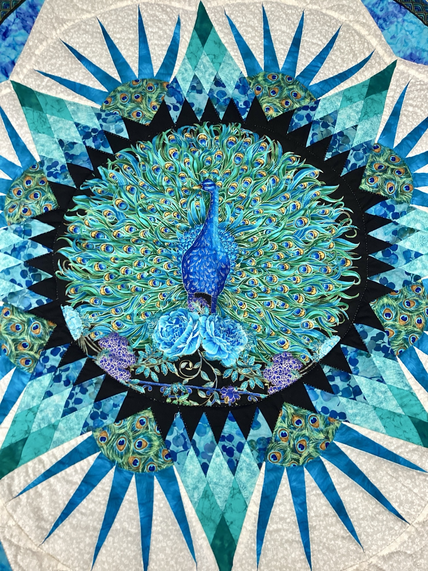 Handmade peacock wall hanging quilt with teal and sapphire blue fabrics