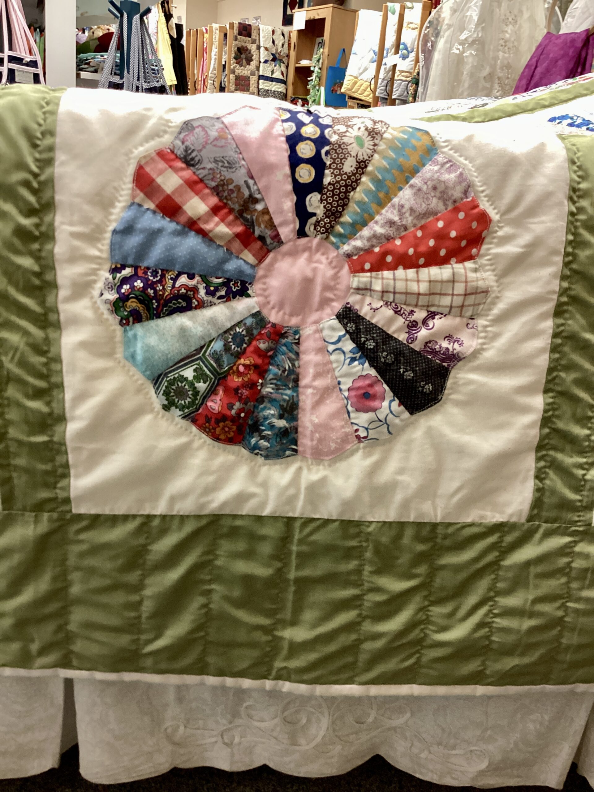Close up: Handmade Lancaster County vintage Dresden Plate quilt with authentic 1940s fabrics and hand quilting in Twin throw size