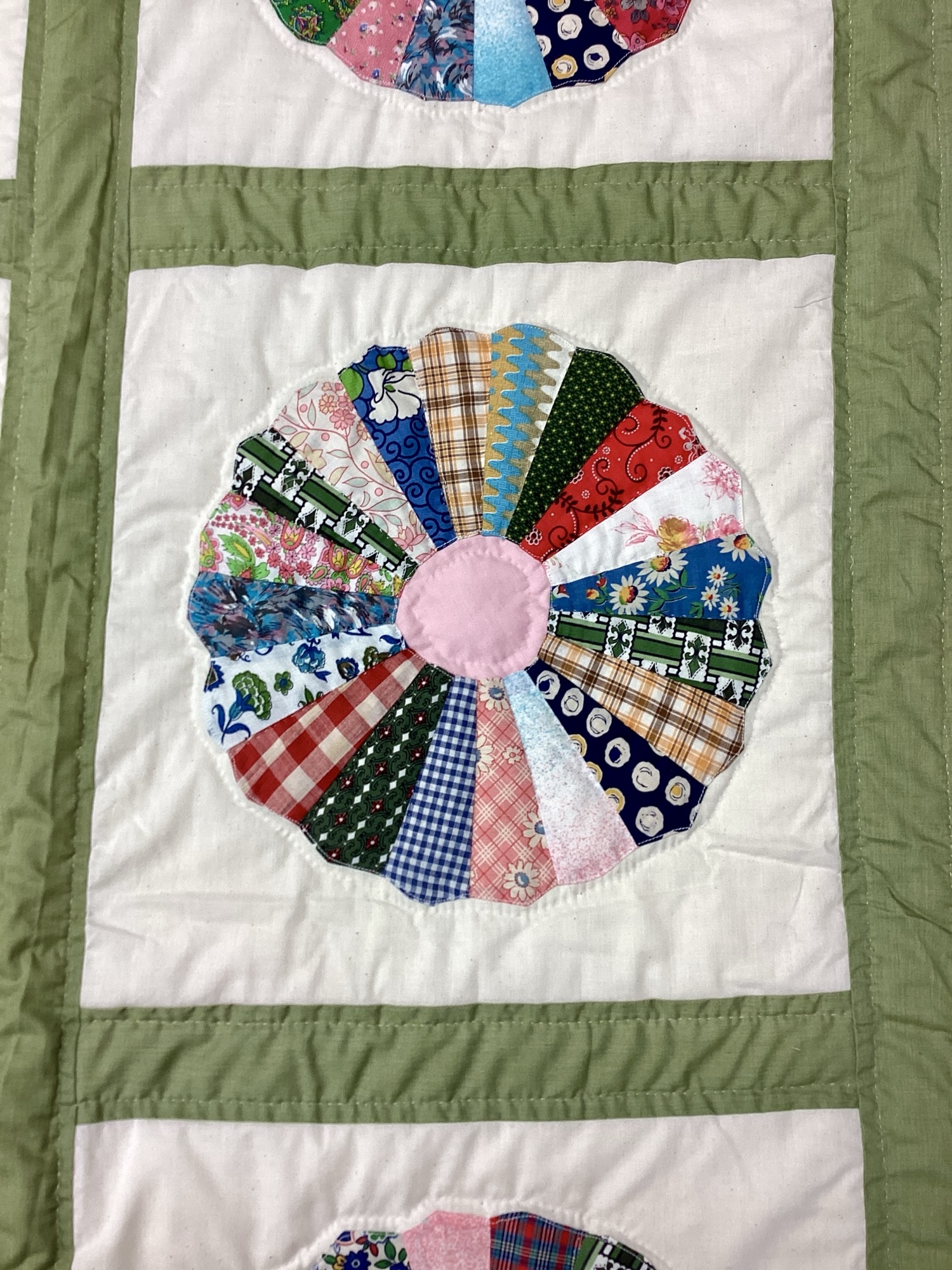 Close up: Handmade Lancaster County vintage Dresden Plate quilt with authentic 1940s fabrics and hand quilting in Twin throw size