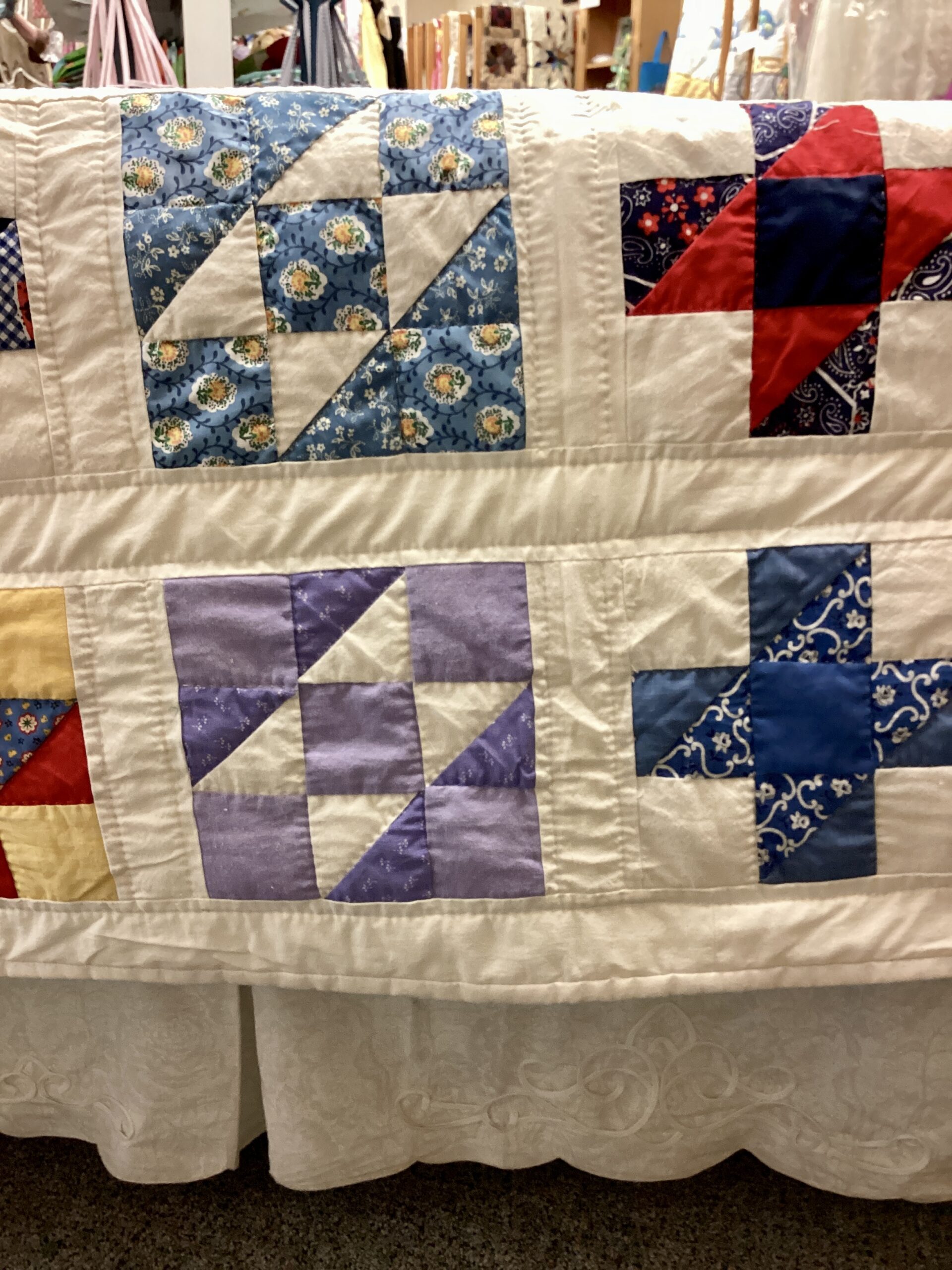 Close up of Handmade Lancaster County vintage sampler quilt using authentic 1940s fabrics with hand quilting in Twin throw size