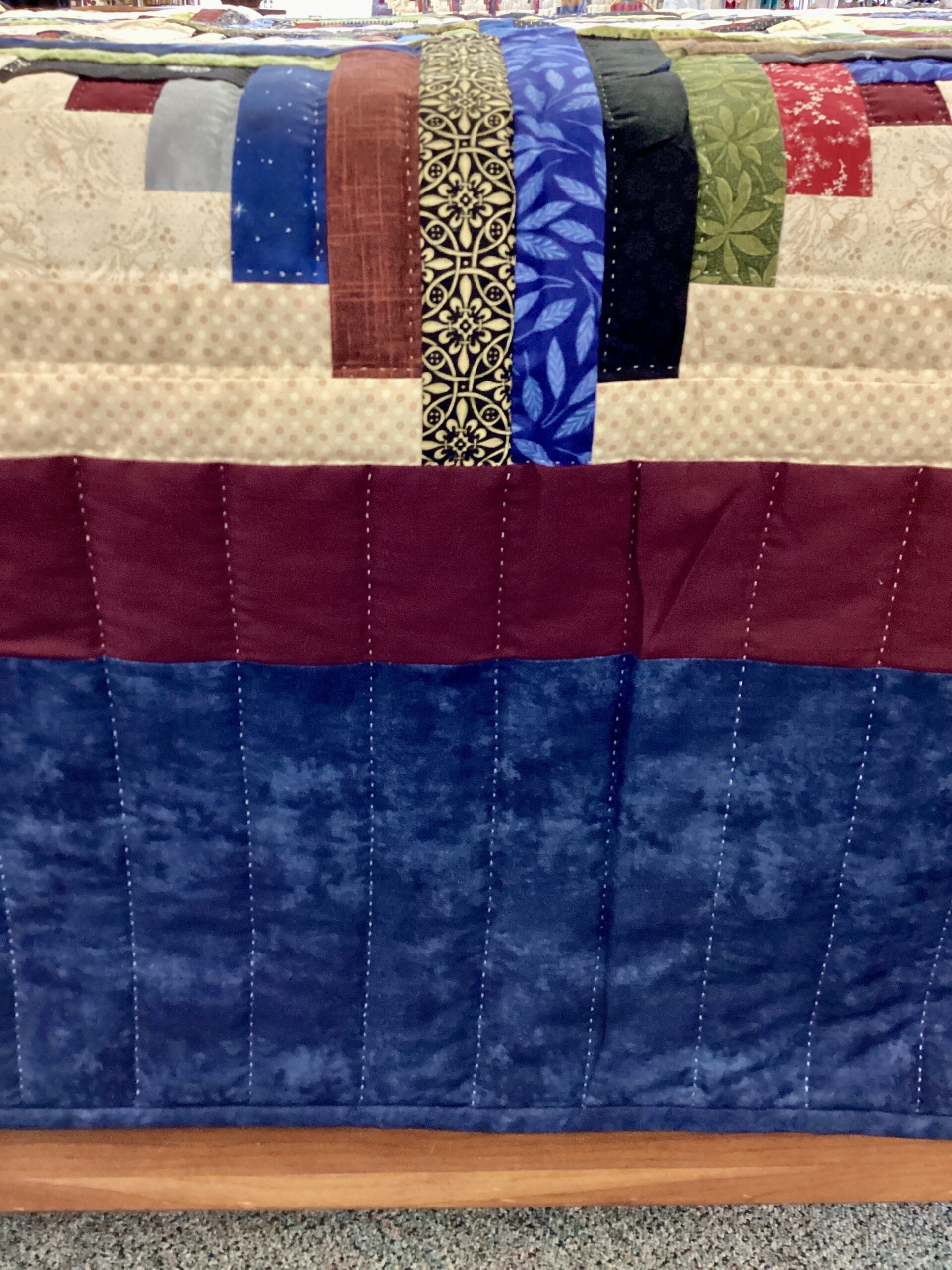 Navy and burgundy border with hand stitching on Lancaster County Amish Log Cabin quilt