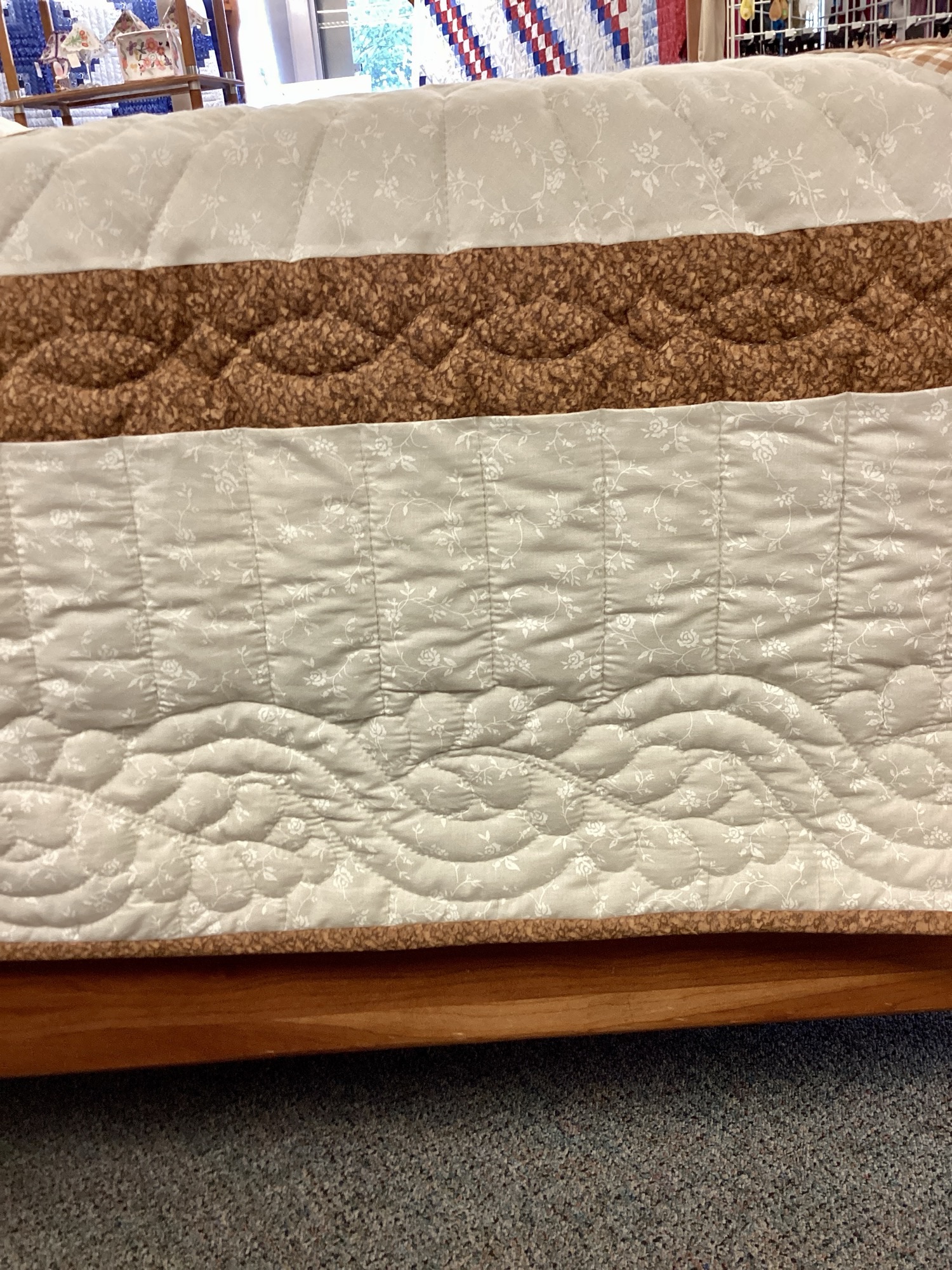 Border and Stitching on Handmade Lancaster County Amish Lone Star quilt with floating cream, sky blue and brown star design, feather quilting and floral backing