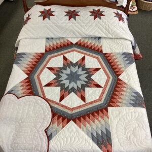 Handmade Lancaster County Amish Maryland Star quilt with red, white and gray center star, octagon border, feather quilting and scalloped edges
