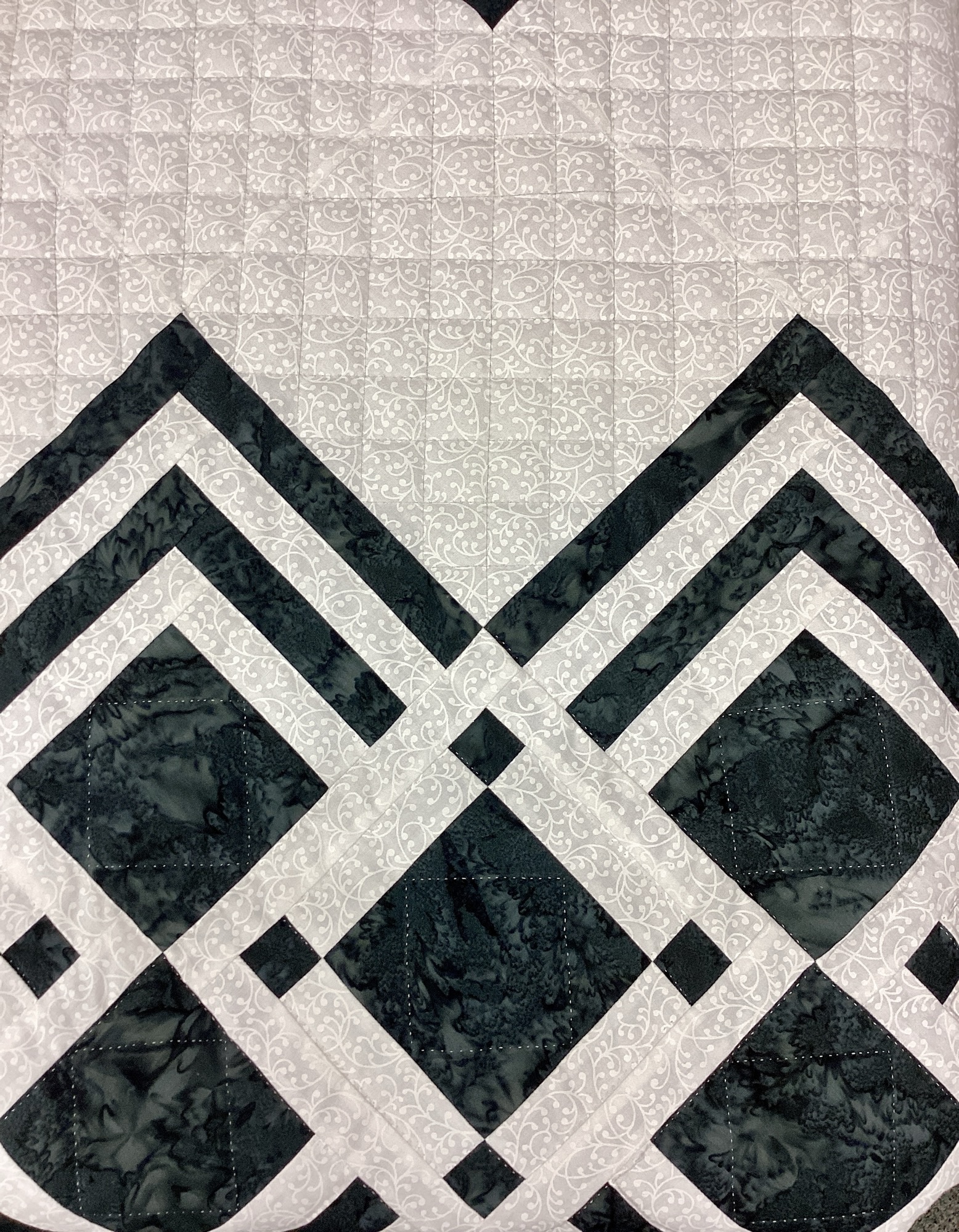 Detailed view of hand quilted grid pattern on cream background of Queen of Diamonds quilt