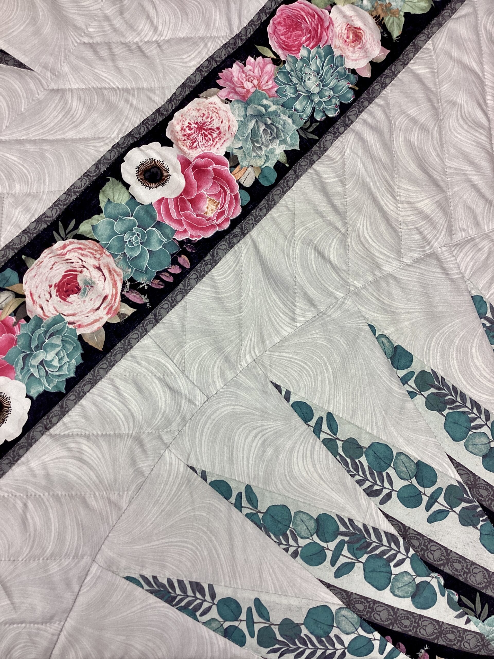 Close up of detail on Sawtooth Medallion Amish Quilt with floral fabric