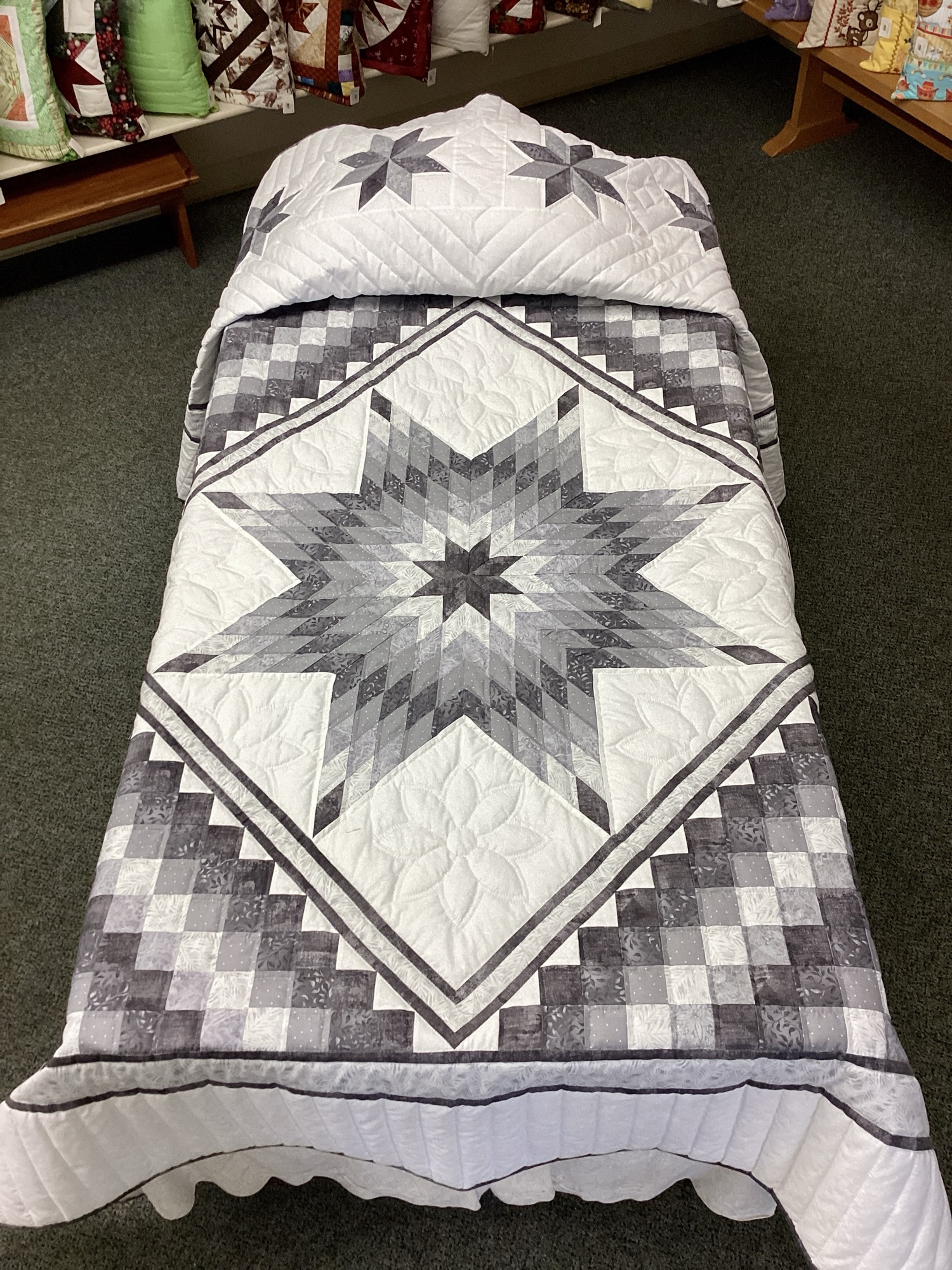 Handmade Lancaster County Mennonite Star N Common quilt with gray and silver center star, pieced Boston Common border, floral hand quilting, and scalloped edges